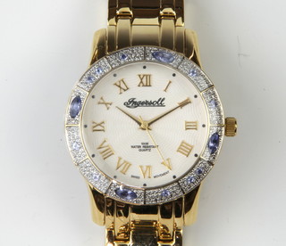 A lady's gilt Ingersoll quartz wristwatch with gem set bezel in original box 