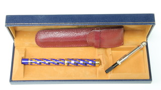 A lady's Waterman fountain pen with blue and gilt chequerboard case and 18ct nib contained in original box 

