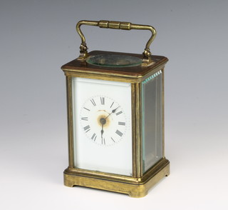 A 19th Century French 8 day carriage time piece with enamelled dial and Roman numerals contained in a gilt metal case 13cm x 9cm x 8cm (overwound)
