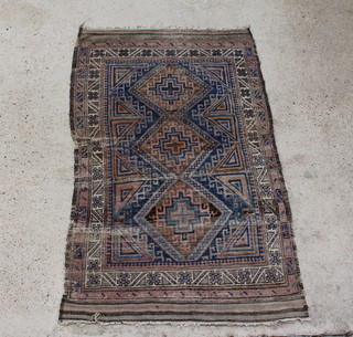 A blue and tan ground Belouche rug with 3 diamonds to the centre within a multi row border 187 x 107cm