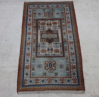 A Caucasian style brown and green ground Turkey rug with central medallion within a multi-row border 248cm x 146cm 