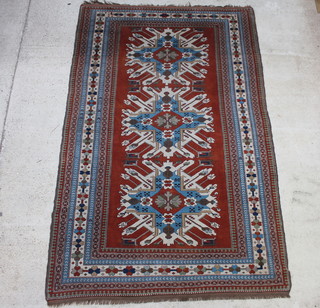 A brown and blue ground Caucasian style Turkey rug with 3 medallions to the centre within a multi-row border 348cm x 222cm 