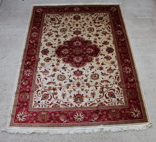 A gold and red ground Kashan style carpet with central medallion 280cm x 200cm 