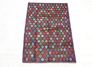A black ground Belouch rug with all-over geometric stylised star design 186cm x 124cm 