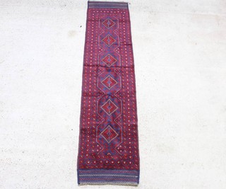 A red and blue ground Meshwani runner with 6 diamonds to the centre within a multi row border 257cm x 65cm 