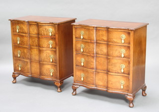A pair of Queen Anne style figured walnut bedside chests of serpentine outline with crossbanded tops, fitted 4 long drawers with brass pear drop handles, raised on cabriole supports 68cm h x 60cm w x 36cm d 