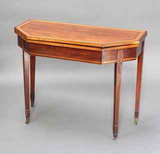 A Georgian inlaid mahogany card table of lozenge form with crossbanded and ebonised stringing, raised on square tapered supports, spade feet 74cm h x 93cm w x 46cm d