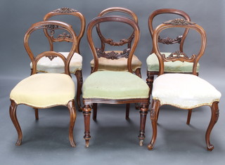 A harlequin set of 6 Victorian dining chairs comprising a pair of carved walnut balloon back chairs with pierced mid rails and seats of serpentine outline, a pair of rosewood balloon back chairs with carved mid rails and upholstered seats raised on turned supports and 2 other similar rosewood chairs 
