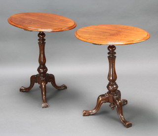 A pair of 19th Century oval mahogany wine tables, raised on turned and fluted column with tripod base 70cm m h x 60cm w x 45cm d 