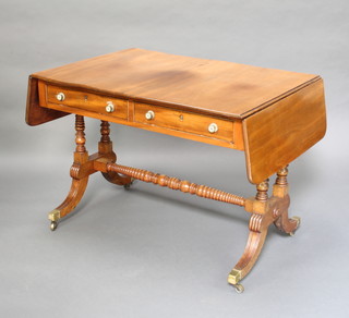 A Georgian mahogany sofa table fitted 2 frieze drawers and raised on turned supports  with bobbin turned H framed stretcher ending in brass caps and casters 72cm h x 68cm h x 99cm x 149cm when extended 

