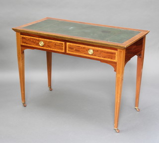 An Edwardian Sheraton style inlaid mahogany writing table with inset writing surface, satinwood and ebony stringings, fitted 2 long drawers, raised on square tapered supports ending in ceramic casters 76cm h x 107cm w x 55cm d 