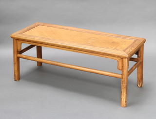 A Chinese rectangular light Padauk stool/coffee table with rattan panel to the centre 43cm h x 107cm w x 43cm d 

