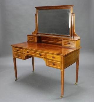 Gillows, a Victorian inlaid mahogany dressing table with raised mirrored back, the base fitted 2 glove drawers above 1 long and 4 short drawers, raised on square tapered supports ending in brass caps and casters 122cm w x 61cm d x 149cm h