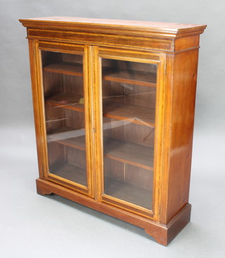 A Victorian rectangular inlaid mahogany  display/bookcase with moulded and cross banded cornice, fitted adjustable shelves enclosed by glazed panelled doors, raised on bracket feet 118cm h x 106cm w x 33cm 