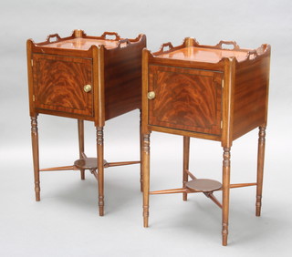 A pair of Georgian style mahogany tray top bedside cabinets fitted cupboard, raised on turned supports with X framed stretcher 76cm h x 39cm w x 39cm d 