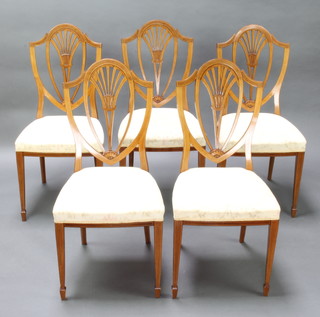 Waring & Gillow, a set of 5 inlaid mahogany Sheraton revival shield back dining chairs, upholstered with overstuffed seats, raised on square tapered supports and spade feet 