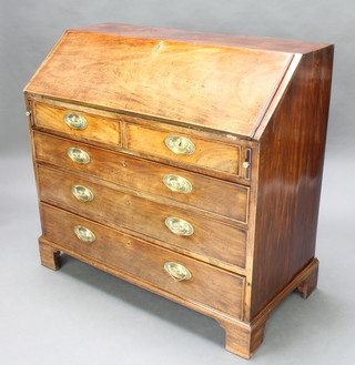 A Georgian mahogany bureau, the fall front revealing a well fitted interior above 2 short and 3 long drawers with oval brass plate drop handles, raised on a bracket feet 102cm h x 108cm w x 52cm d 