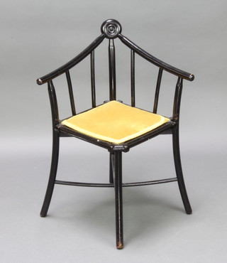 An Aesthetic Movement ebonised stick and rail back corner chair with X framed stretcher 