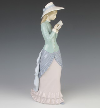 A Lladro figure of a girl reading a book 5000 36cm 