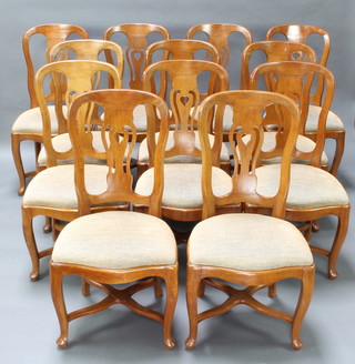 A set of 12 Dutch fruitwood slat back dining chairs with upholstered drop in seats, raised on cabriole supports with X framed stretchers 