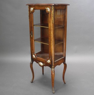 A French Empire style mahogany cabinet of serpentine outline, the interior fitted shelves with gilt metal and porcelain mounts, raised on cabriole supports 121cm h  x 49cm w x 34cm d 