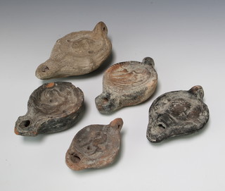 A Roman style earthenware oil lamp with mask decoration 14cm and 4 others 