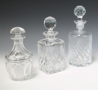 A mallet shaped decanter and stopper 19cm, a cylindrical do. 25cm and a spirit decanter 22cm 