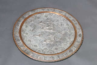 A circular "Persian" embossed copper and white metal charger decorated a hunting scene 58 1/2cm  