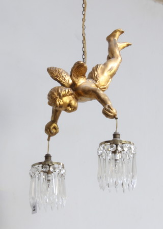 A gilt metal light fitting in the form of a flying cherub holding 2 circular drop lustres approx. 34cm l x 27cm w 
