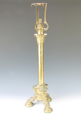 A Victorian brass adjustable table lamp raised on a Corinthian capital column with triform base and Rococo style feet, the top with Palmer & Co Patent lamp holder 80cm h x 26cm w