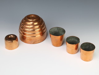 A Victorian cylindrical ribbed copper jelly/ice cream mould 10cm x 12cm, a smaller do. 4cm x 5cm and 3 other moulds/measures 