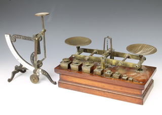 Waterlow and Sons of London, a pair of 19th Century brass and mahogany scales with 8 weights - three 8oz, one 4 oz, one 2 oz, one 1 1/2 oz, one 1 oz, one 1/2 oz (missing 2 weights) together with a brass and iron balance  