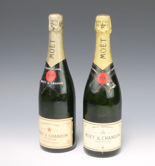 A bottle of Moet & Chandon  Premier Cuvee champagne and 1 other labelled Brut Imperial 