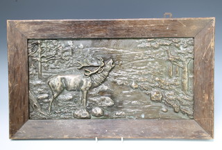 A rectangular bronze  plaque of a stag by a river 22cm x 44cm contained in an oak frame 
