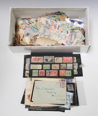 A collection of Victorian and later loose stamps together with stamped envelopes 