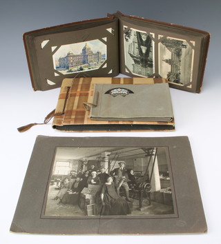 An album of black and white postcards of Lithuania, an album of black and white and coloured postcards including Germany and America together with a 1930's black and white photograph album New York scenes and 2 black and white photographs of staff from a tobacco factory 