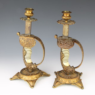 A pair of 19th Century hilt candlesticks, the bases formed from Spanish/Italian Naval Officers sword hilts 26cm x 10cm x 10cm 