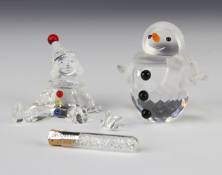 A Swarovski Crystal snowman 5.5cm and a seated clown 5cm, boxed 