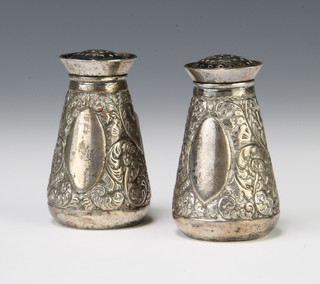 A pair of Victorian repousse silver condiments with scrolls and flowers and vacant cartouche Sheffield 1889 5.5cm 