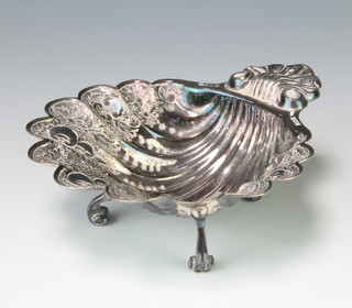 A repousse silver shell shaped butter dish with floral decoration Birmingham 1974 maker Davidson Henderson and Sorley 124 grams, 13.5cm 