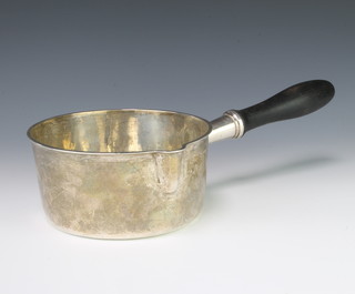 An early 19th Century French silver saucepan with turned wood handle, gross 426 grams 34cm