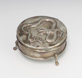 A Chinese repousse silver circular trinket box decorated with a dragon, maker Cumwo, 122 grams, 8cm 