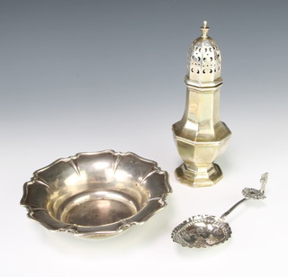 An octagonal silver sugar shaker Sheffield 1933, a silver bowl and spoon 279 grams 