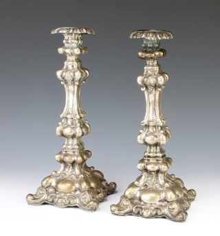 A pair of 19th Century Continental repousse silver candlesticks of Rococo form 30cm, 731 grams 