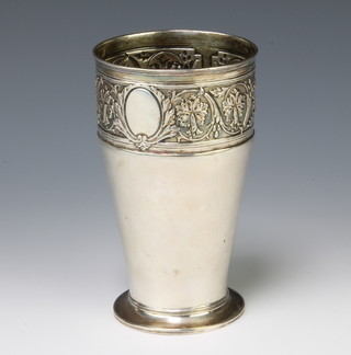 A Continental repousse silver beaker decorated with scrolls and vacant cartouche 145 grams, 15cm 