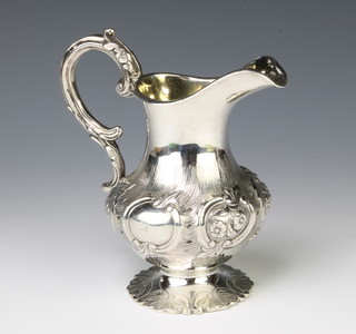 A Victorian repousse silver cream jug with S scroll handle and floral decoration London 1842 Maker Samuel Hayne & Dudley Carter 266 grams, 15cm 