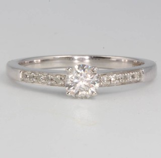 A 9ct white gold single stone diamond ring with diamond shoulders, 0.50ct, size M 1/2