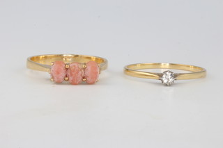 An 18ct yellow gold 3 stone coral ring size R 1/2 and a yellow gold single stone diamond ring 0.2ct size R 