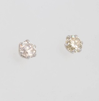 A pair of platinum single stone diamond ear studs, approx 0.30ct
