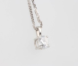 An 18ct white gold single stone diamond pendant, approx. 0.74ct on a do. chain 